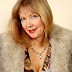 First pic of  Older lady strips her fur coat and dress to pose in black nylons