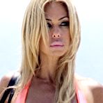 Third pic of Shauna Sand in shiny orange bikini