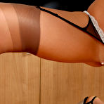 Fourth pic of Cuties in Stockings - Kitty poses in red stockings and Santa's hat on camera