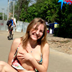 Fourth pic of Public flashing - Busty exhibitionist babe walks in the rain topless