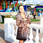 Fourth pic of Public flashing - Busty exhibitionist babe walks in the rain topless