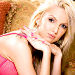 Second pic of porn star Taylor Tilden fondling her bald pussy on the leather couch!