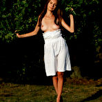 Fourth pic of Gorgeous long haired honey taking off her clothes and posing absolutely naked outdoors.