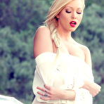 Second pic of Brea Bennett fingering her flawless pussy on top of her classic car