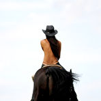 Second pic of Melisa Mendiny - Melisa Mendiny rides her strong black horse outdoors wearing nothing but pants.