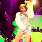 Third pic of Miley Cyrus without bra under fishnet dress