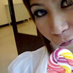 Third pic of Sexy schoolgirl Thai baby named O sucks a lolipop and shows off her bald pussy