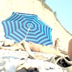 Third pic of Naughty young nudists play with each other in sand