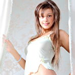 Fourth pic of Gorgeous teen beauty with excellent straight long hair showing shaved pussy on the bed.