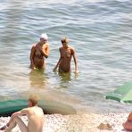 First pic of Naughty young nudists play with each other in sand