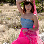 First pic of Brunette lays on the ground in the hot sunshine while she reveals every bit of her stunning sexiness.
