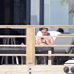 Fourth pic of Cara Delevingne sunbathing topless on a balcony