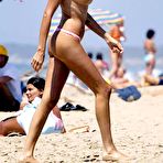 First pic of Stefania Orlando sunbathing topless on a beach