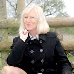 Third pic of Mature lady flashing her nyloned legs outdoor at Sandy's Secrets