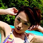 Second pic of Sexy Japanese girl poses in her colorful bikini at the beach and gets her nice tits and ass all wet.