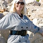First pic of Mature lady in ff nylons in sunglasses poses on a beach showing titties
