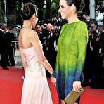 Fourth pic of Evangeline Lilly posing in short dress shows her long legs at premiere