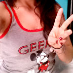 Second pic of Busty dark haired Freckles poses and shows her boobs for the camera on bed