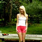 First pic of Blonde teenager Sierra Nevadah sets on the green lawn and dildo fucks the beaver