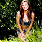 Second pic of Sexily dressed up Aidra Fox is excitingly posing on the grass and spreading her legs to show off her pussy