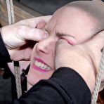 Fourth pic of SexPreviews - Bella Rossi is bound in wood with mouth spreader with clamps on her big tits