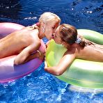 Fourth pic of Bestial goldilocks Cynthia and her tanned lover Tiffany Rose greedily eat cunts by the pool.