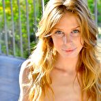 Fourth pic of Softcore queen Bethanie Skye slowly slips out of her long yellow dress while masturbating.