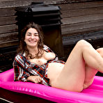 Third pic of Naturally busty girl Livia teasing outdoors in the rain at PinkWorld Blog