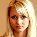 First pic of The seducing blonde Pinky June is lifting her red dress up uncovering view on shaved pussy