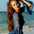 Fourth pic of Blue eyed brunette Nicole K shows her smelting hot body on a desert island beach.