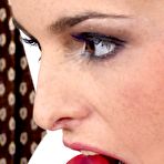 Third pic of Gaby Black in plaits and stripy stockings teasing her juicy slit with a double end red dildo.