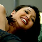 Third pic of Sexy assed asian Mika Tan in black nylons takes green robotic dildo from behind