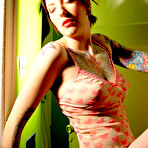 First pic of Short haired goth chick Erica shows off her tattoos and nicely shaped tits