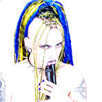 Second pic of Gun girl Jenner Christ with tattoos and piercing poses in blue corset and black boots