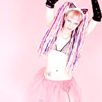 Third pic of Alternative blonde Chaotica with pink and white hair shows her pierced nipple and bald pussy