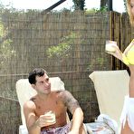 First pic of Busty blonde MILF Jodi West wraps her arms around a young stud and blows his boner poolside.