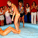 Second pic of Samantha Wow and her opponent lose their tops and bare their tits after oil wrestling match begins