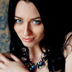 Fourth pic of Zsanett Tormay shows off her sexy, tight body as she sensually poses on the sofa.