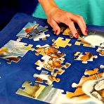 First pic of Rea Rich has fun completing the puzzle and showing her bare feet and smooth pussy