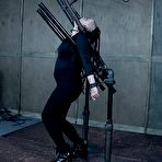 Third pic of SexPreviews - Luna LaVey bound in metal with tits exposed and pussy toyed in dungeon