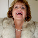 Second pic of Busty Bliss Hot Mommy Poses in White Fur with Bikini and Tanlines