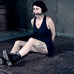 Third pic of SexPreviews - Olive Glass corset maid is bound in metal with dripping mouth gag