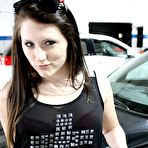 Second pic of Naughty brunette Freckles strips down to her red lingerie and sprawls all over that muscle car