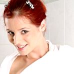 Third pic of Busty cutie Piper Fawn shows off her hairless pussy after removing her black bikini in the bathtub