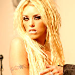 Fourth pic of Long haired busty blonde Brittney Skye in black blouse poses in red skirt and without it