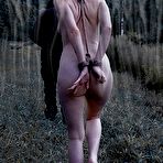 Fourth pic of SexPreviews - Sierra Cirque is rope bound outdoors to wooden stock for sex with maledom