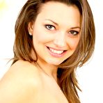 Third pic of Stripping brunette girl Amiee R shows her fine smile and sexy nyloned legs