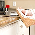 First pic of Short-haired MILF with round breasts posing on all fours on a counter - IamXXX.com