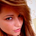 Fourth pic of Colorfully dressed tanned young hottie slowly undressing on camera - IamXXX.com