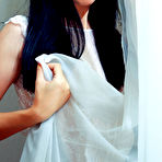 First pic of Skinny brunette dressed in white shows her smooth labia to the viewer - aMetart.com